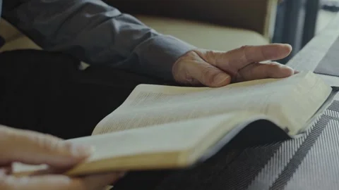 Close up of hands of white businessman Reading the Bible in a Room Video stock 303208705