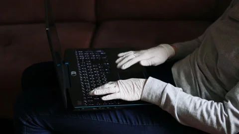 Close up of hands in white gloves typing code or text on a keyboard of laptop Stock Footage 152969729