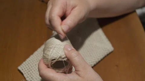Close-up of Hands Winding Yarn Ball for Crochet Project Stock Footage 342559102