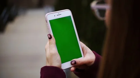Close up hands woman holding using smartphone with green screen on the street Stock Footage 105203729