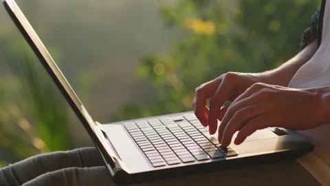 Close-up hands of woman typing fast on laptop outdoors. Stockbeeldmateriaal 244329331