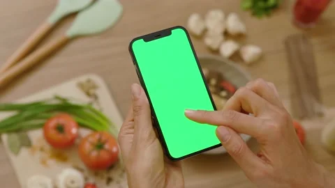 Close up hands woman use touch phone with vertical green screen. Background Stock Footage 144962397