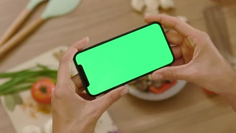 Close up hands woman use touch phone with horizontal green screen. Background Stock Footage 144962468