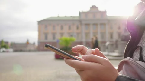 Close up hands of woman using smartphone in town with big building background Video stock 177941299