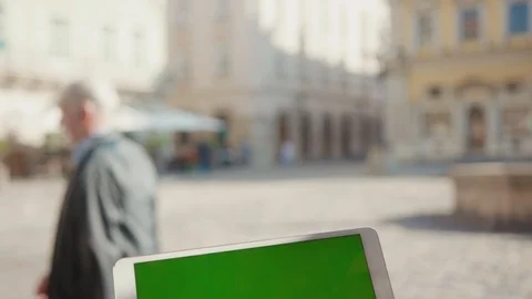 Close up hands woman using tablet device computer with green screen outdoors in Stock Footage 116442173