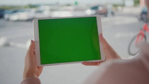 Close up hands woman using tablet device computer with green screen outdoors in Stock Footage 116462184