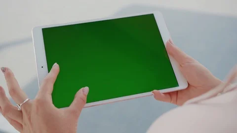 Close up hands woman using tablet device computer with green screen outdoors in Stock Footage 116462220