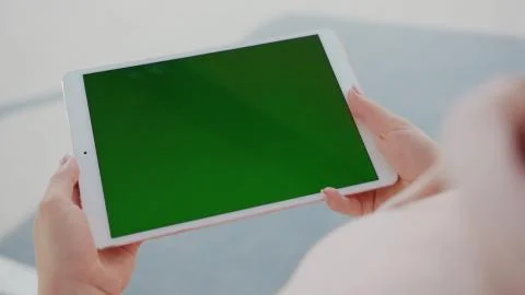 Close up hands woman using tablet device computer with green screen outdoors in Stock Photos
