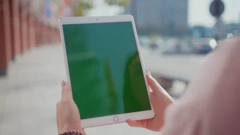 Close up hands woman using touch tablet device computer with green screen Stock Photos