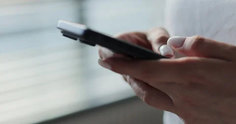 Close-up of hands of woman writes a text message on smartphone 스톡 동영상 335883961