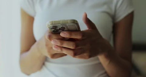 Close-up of hands of woman writes a text message on smartphone Stock Footage 336654096