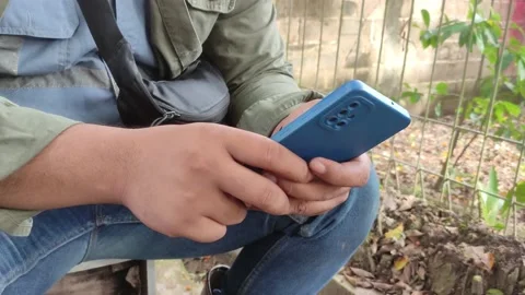 Close-up hands of worker man typing message on mobile phone outdoors . Stock-Footage 221993889