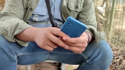 Close-up hands of worker man typing message on mobile phone outdoors . Stock-Footage 221993931