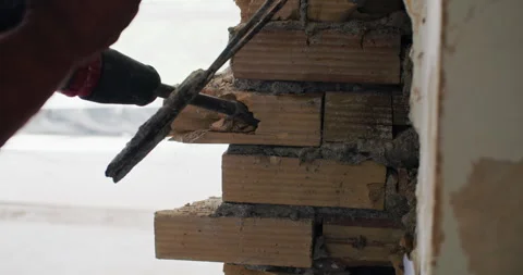 A close-up of the hands of a worker who destroys a wall with a jackhammer. Stock Footage 245363516