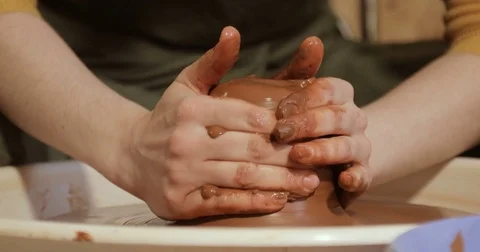 Close up of hands working clay on potter's wheel Stock Footage 74728172