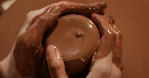 Close up of hands working clay on potter's wheel, Top view, close-up view Stock Footage 74728869