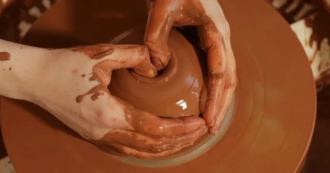 Close up of hands working clay on potter's wheel, Top view, close-up view Stock Footage 74730185