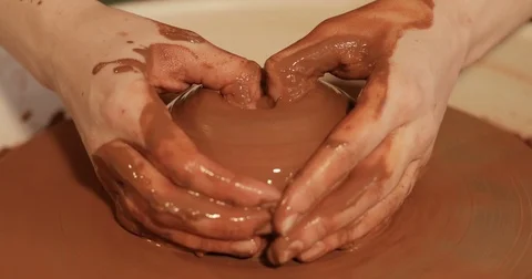 Close up of hands working clay on potter's wheel, Top view, close-up view Stock Footage 74730744