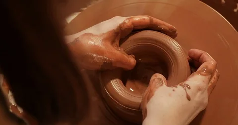 Close up of hands working clay on potter's wheel, Top view, close-up view Stock Footage 74731322