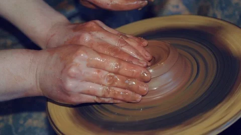 Close up of hands working clay on potter's wheel in studio artisan master Video stock 105266999