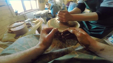 Close up of hands working clay on potter's wheel in sunny studio artisan master 스톡 동영상 105269252