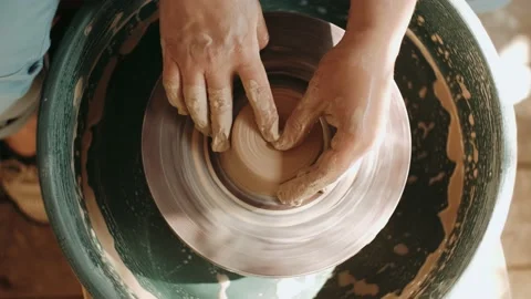 Close up of hands working clay on potter's wheel. top view, craft factory authen Stock-Footage 136176911