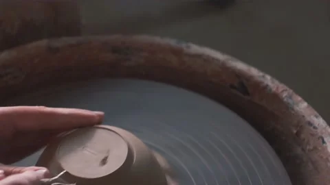 Close up of hands working clay on potter's wheel. Potter shapes the clay product Stock Footage 139887439