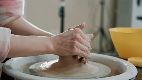 Close up of hands working clay on potter's wheel. Potter shapes the clay product Stock Footage 151717431