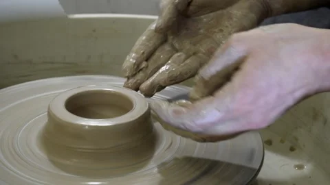 Close up of hands working clay on potter's wheel. Potter shapes Stock Footage 157967662