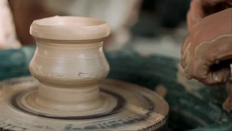 Close up of hands working clay on potter's wheel. Potter shapes the clay product Stock Footage 158120044