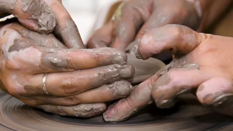 Close-up of hands working with clay on a potter's wheel in a pottery studio.. Stock Footage 328831767