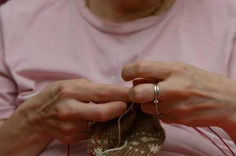 Close-Up of Hands Working on Colorwork Knitting Project Stock Photos