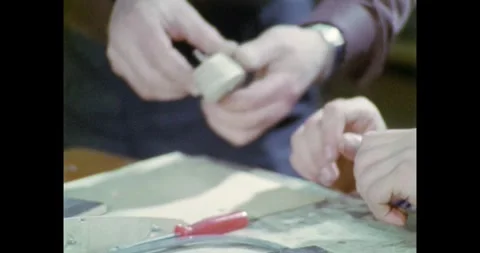 Close-up of Hands Working on a Small Model Part, Teacher Assisting Young Vidéo 318067987