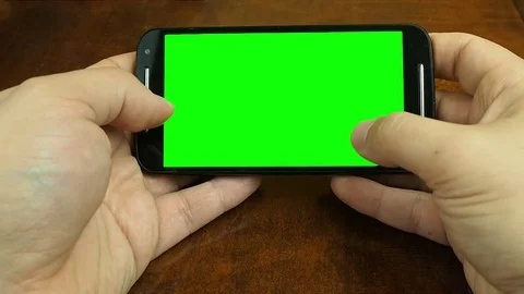 Close up hands working on smartphone at desk blank green screen Stock Footage 72329508