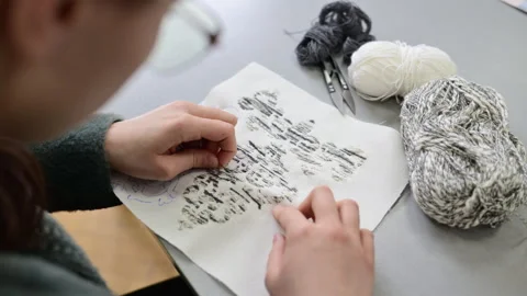 Close up of hands working with textile samples or fabric swatches on a design Stock Footage 335868958