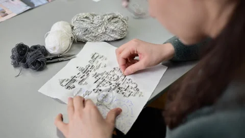 Close up of hands working with textile samples or fabric swatches on a design Stock Footage 335869238