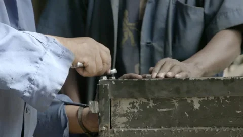 Close up of the hands of workmen as they work on a car engine in Ethiopia. Stock Footage 307429994