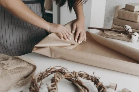 Close up hands wrapping paper Stock Photos
