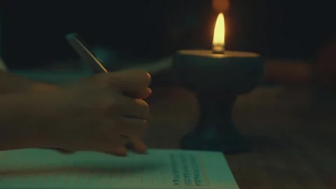 Close-up of Hands Writing Letter by Candlelight at Night Stock Footage 337424748
