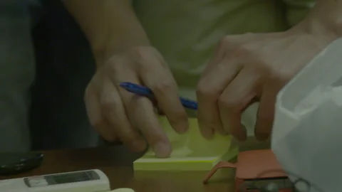 Close Up Of Hands Writing Notes On Sticky Pads 動画素材 341864607