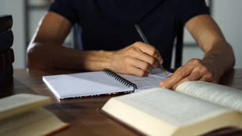 Close-up Hands writting in a notebook on the table. Student studying, education Stock Footage 93250125