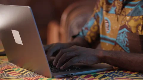 Close-up. Hands of Young African man typing on the computer at home. Stock Footage 345756154