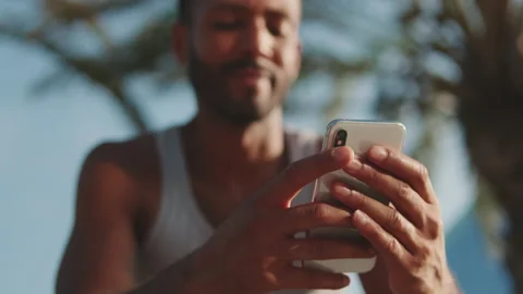 Close-up of hands of young bearded fit sportsman using phone Stock Footage 227088039