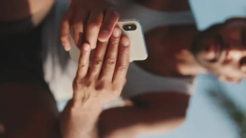 Close-up of hands of young bearded fit sportsman using phone Stock Footage 227090135