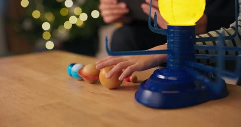 Close-up of the hands of a young boy assembling a solar system. The child is 库存影片 210462905