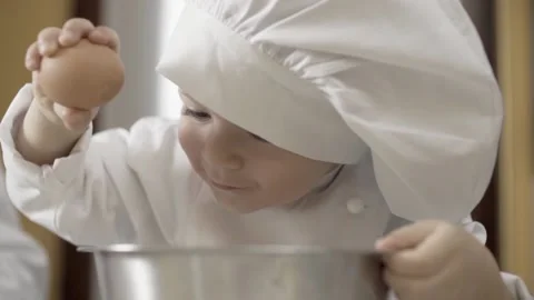 Close-up of hands of a young chef learning to break eggs, hobby. ingredients to Vídeo Stock 156592834