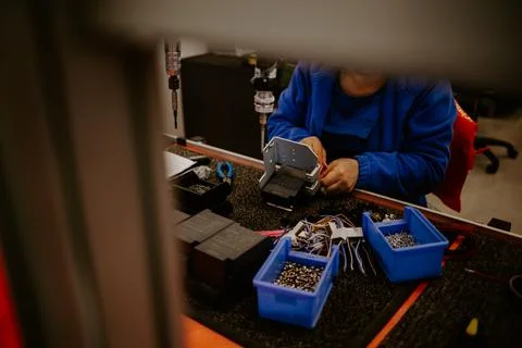 Close-up of hands of young computer engineer fixing broken pc parts at the .. Stock Photos