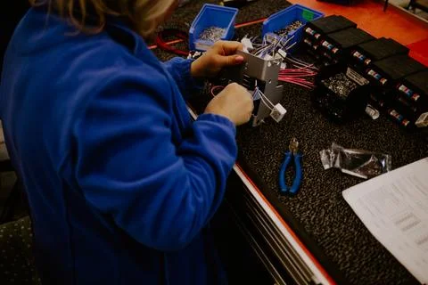 Close-up of hands of young computer engineer fixing broken pc parts at the .. Stock Photos