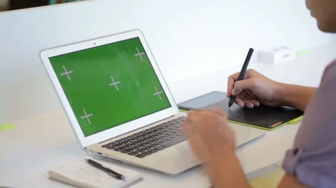 Close up of hands of a young designer using a tablet and a laptop computer Stock Footage 62802789