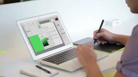Close up of hands of a young designer using a tablet and a laptop computer Stock Footage 62802806